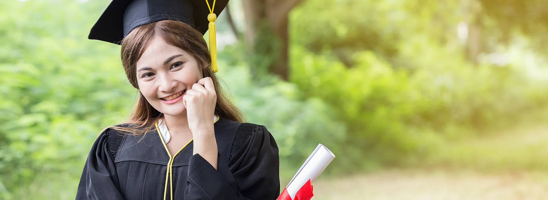Graduate holding a certificate after receiving an academic award