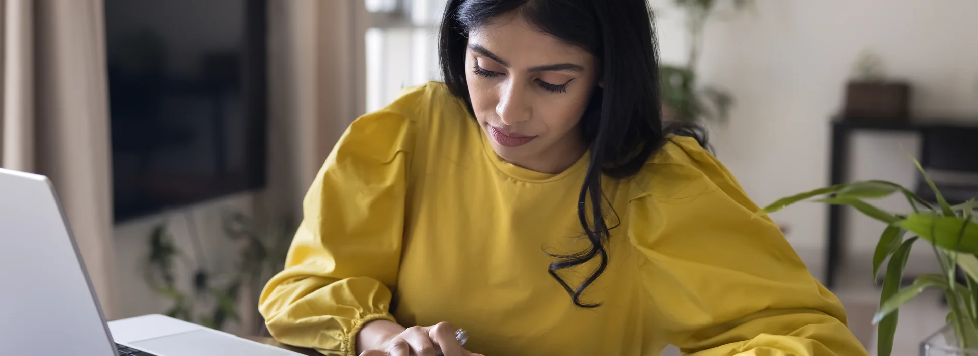 Freelancer reviewing income records and invoices with a calculator
