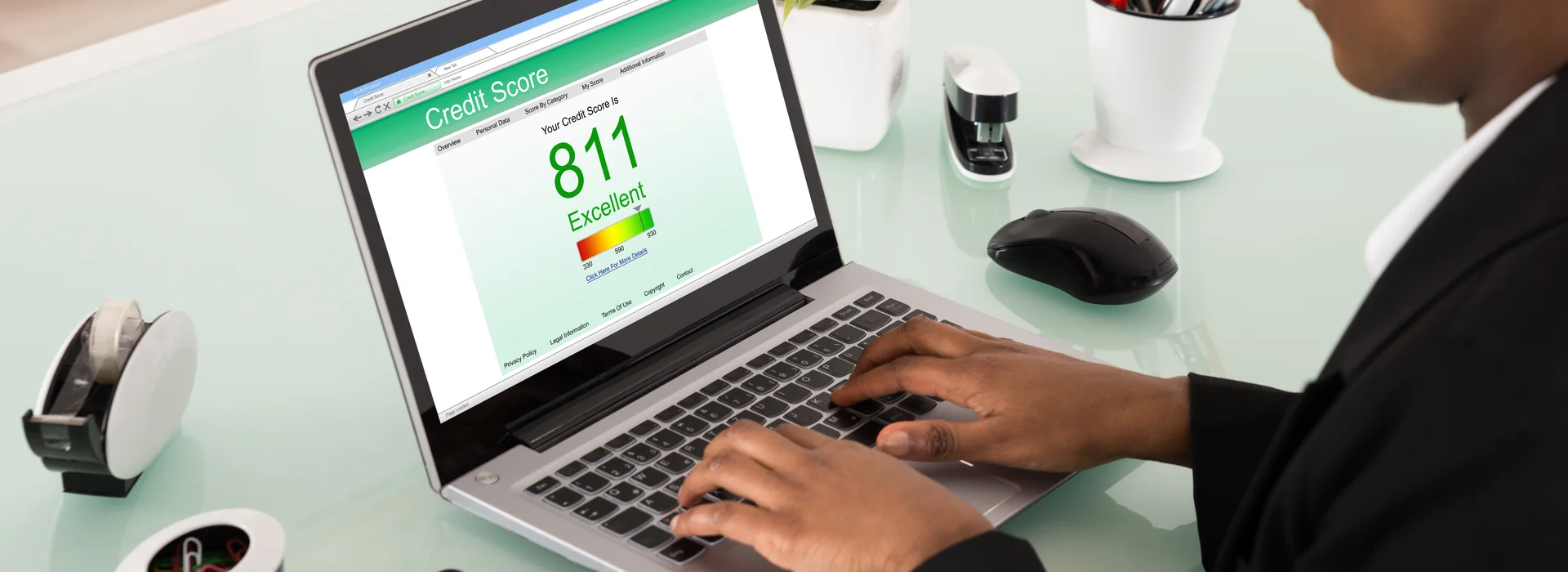 Woman reviewing her credit score on a laptop