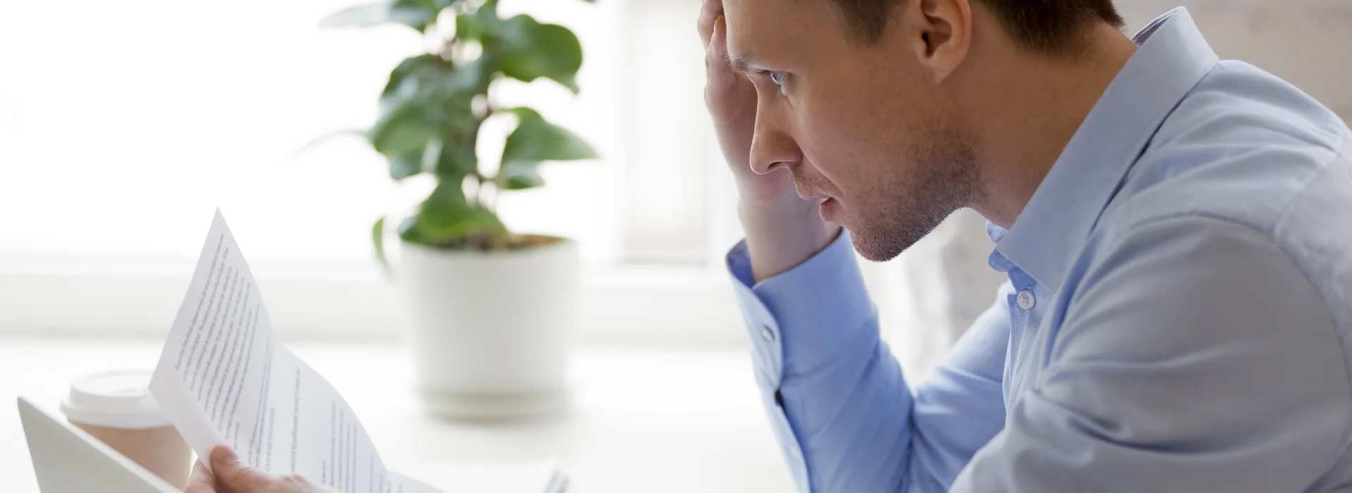 Man reading an unpaid debt notice from a bank