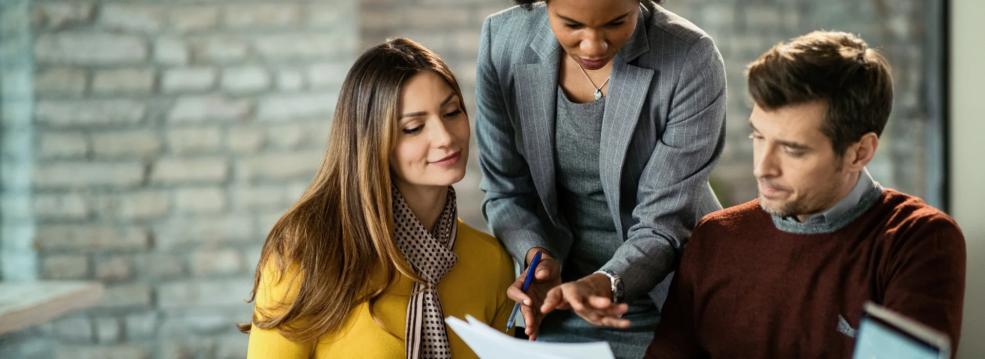 Bank manager explaining short-term loan terms to two customers