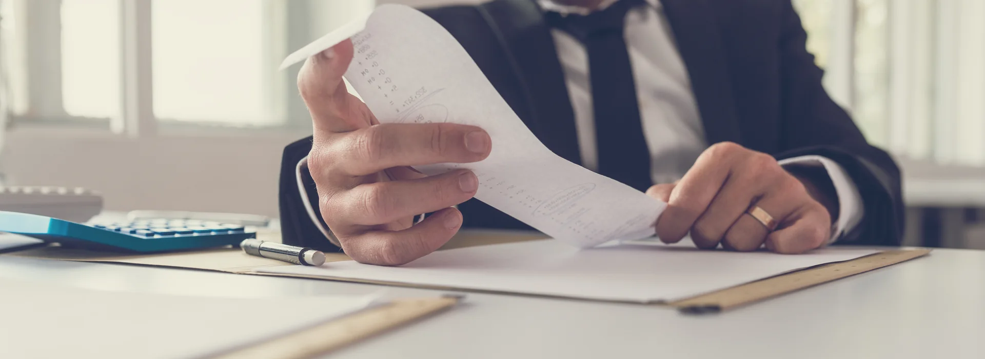Financial advisor reviewing loan documents at a desk