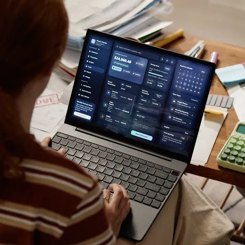 Woman managing household budget on laptop