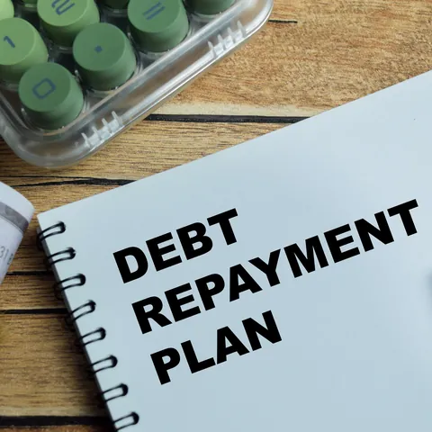 Debt repayment planning write on book isolated on Wooden Table