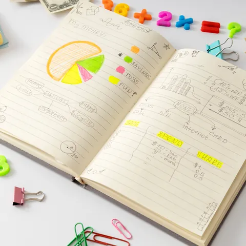 Notebook with financial planning exercises, savings goals