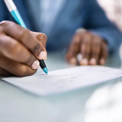 Payroll check and payment documents on a desk