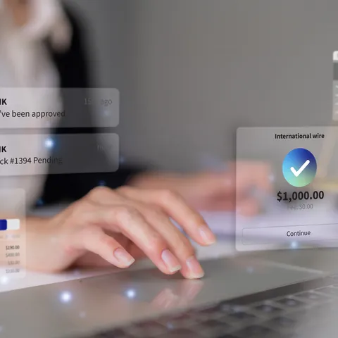 Woman completing an international wire transfer on a laptop
