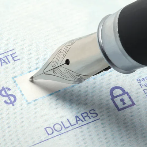 Blank check and pen in close-up