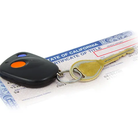 Worn car key on California certificate of Title with crean histo