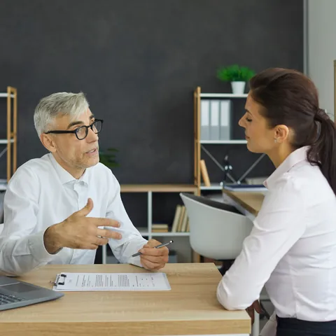 Customer reviewing financial paperwork with a bank employee