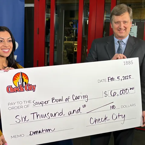 Check City representatives presenting a $6,000 hunger-relief donation check