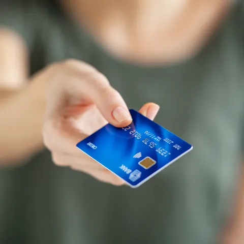 Woman holding a credit card for an authorized user