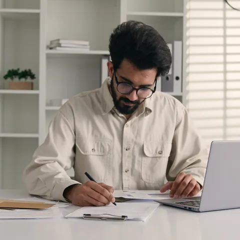 someone doing calculations with cash in hand