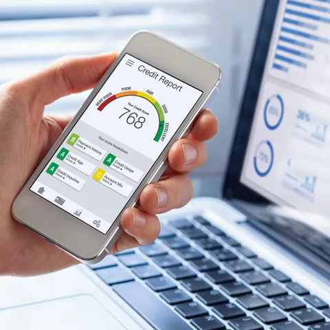 man holding phone showing his credit score going up