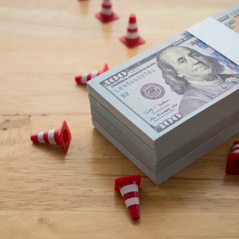 woman pulling cash out of a wallet