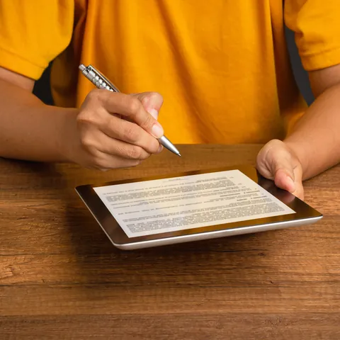 Person signing a payday loan application on a tablet