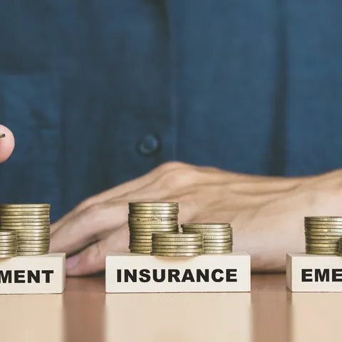 Coins divided among retirement, insurance, and emergency savings