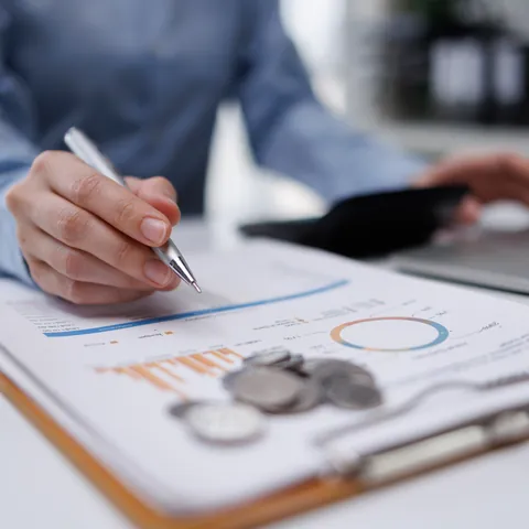 Person reviewing quick-loan paperwork beside a laptop