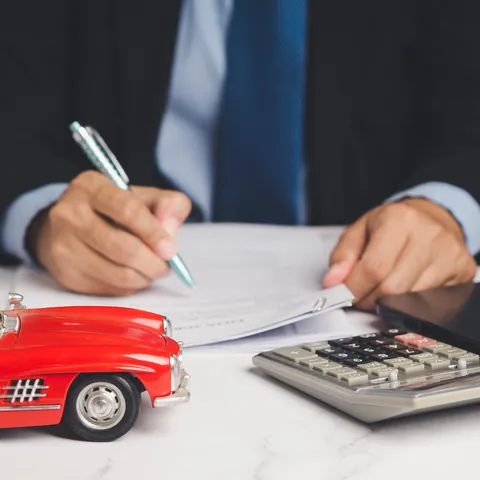 Borrower signing a loan agreement at a desk