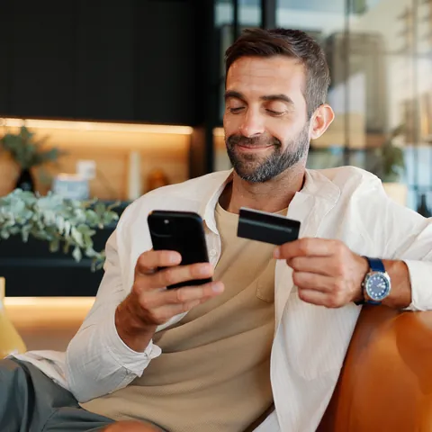 Man using a secured credit card with a smartphone