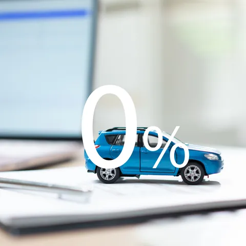 Zero-percent car financing offer beside loan application documents