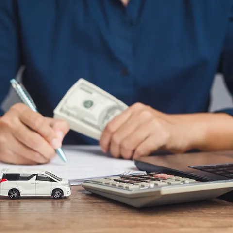 Borrower holding cash while signing a loan agreement