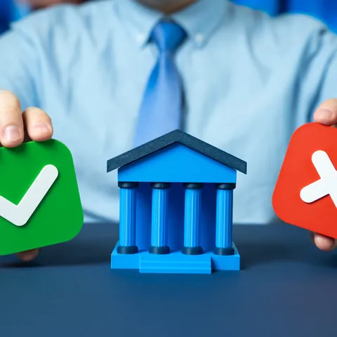Loan approval and rejection choices shown beside a bank symbol