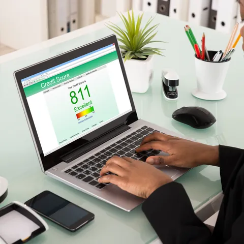 Woman reviewing her credit score on a laptop