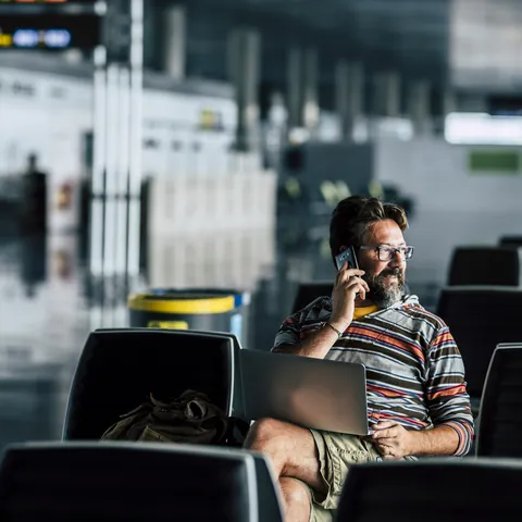 Traveler handling an unexpected trip disruption at an airport