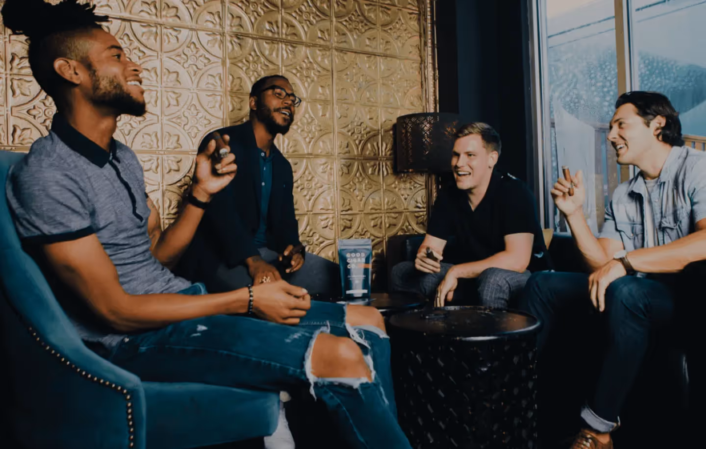 A group of men smoke cigars at Good Cigar Co.