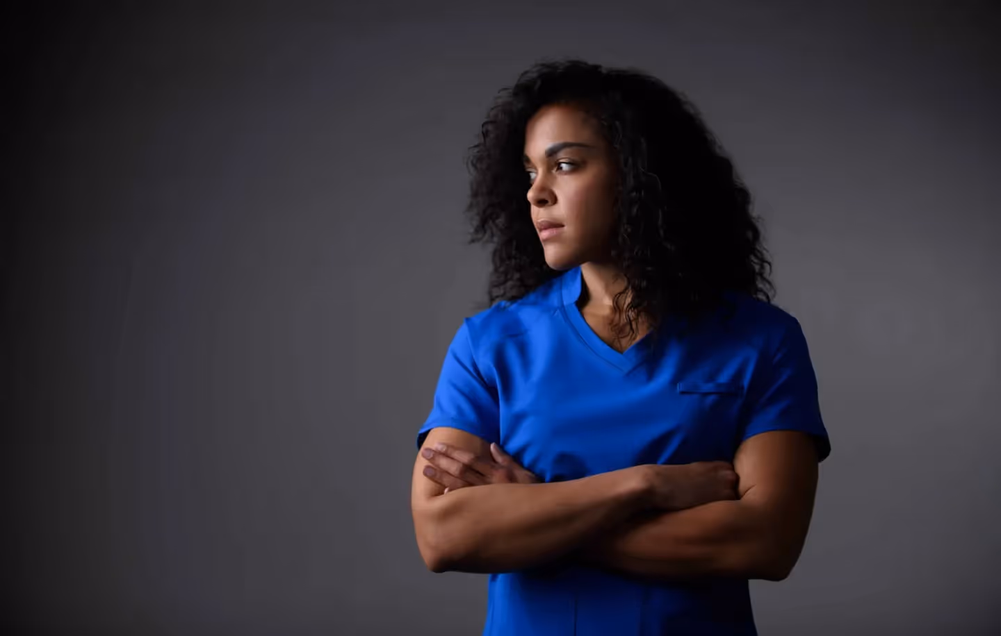 A woman wears an Aegle Gear scrub.