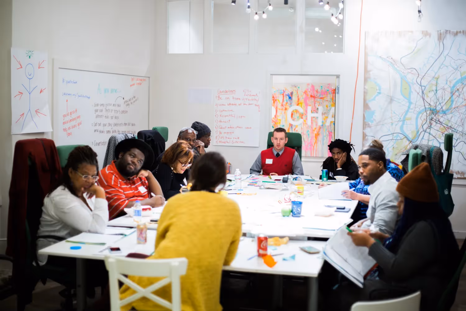 Wide shot of a group of Causeway participants gathered at a conference table.
