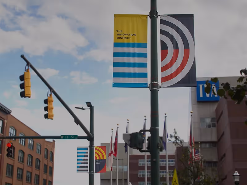 Flagpole showing the Innovation District logo.