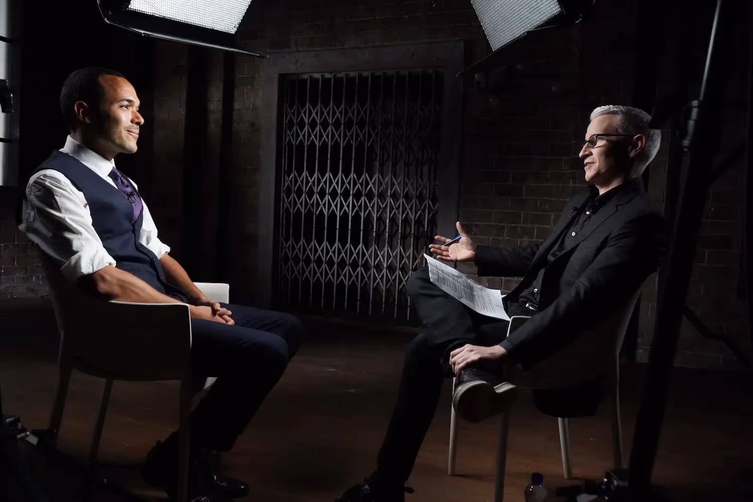 Medium shot of Anderson Cooper talking with Alexander McLean.