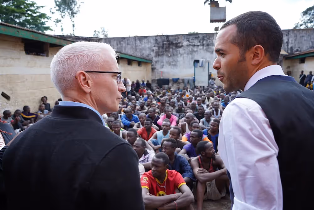 Medium shot of Anderson Cooper talking with Alexander McLean.
