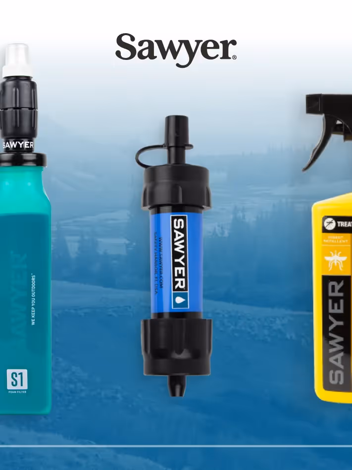 An underwater image of a hiker filling a Sawyer filter.