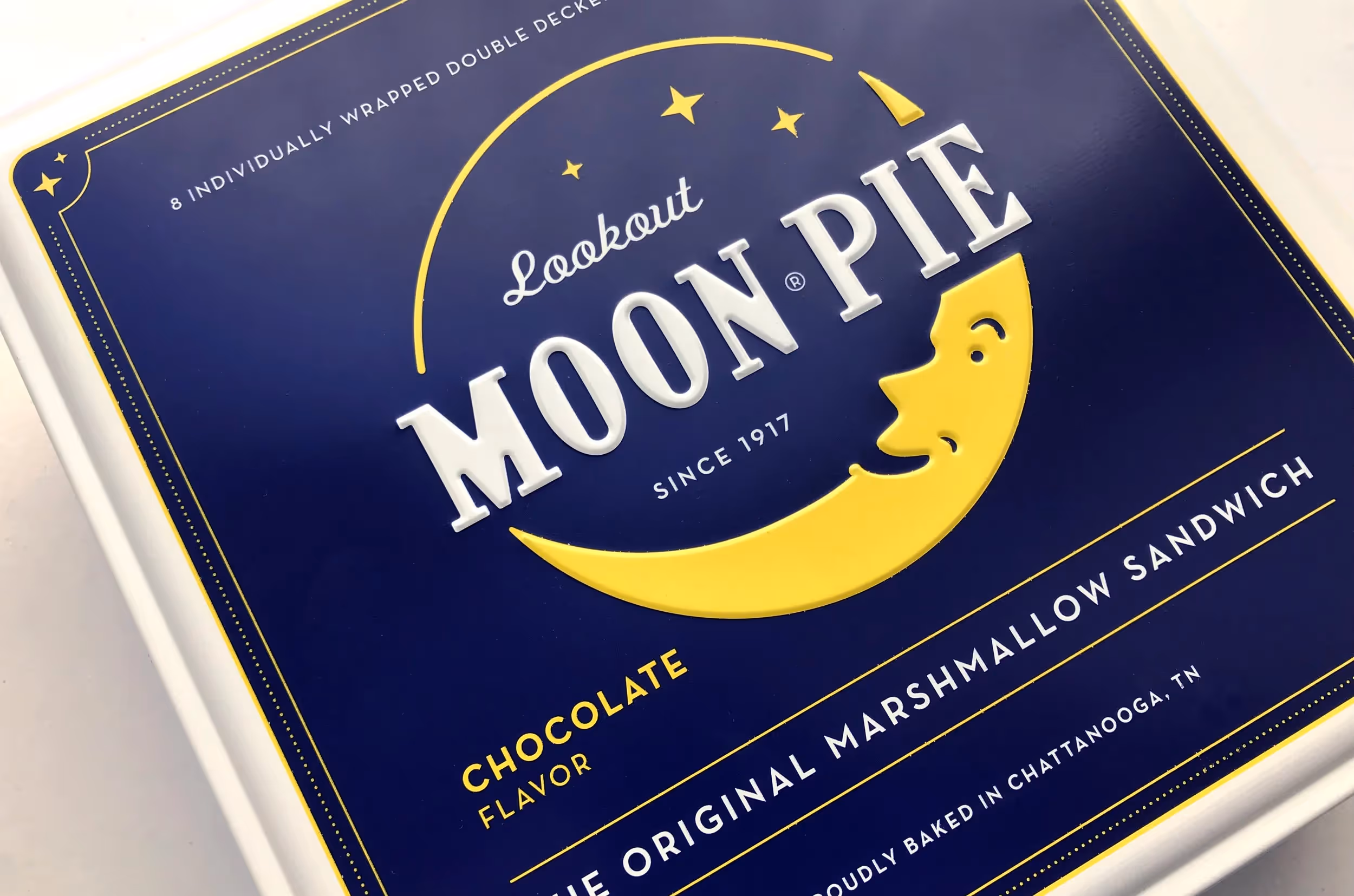 A close-up of a Moon Pie tin.