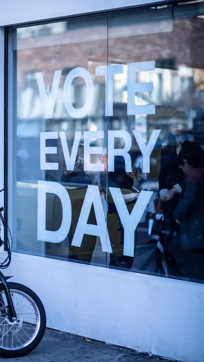 Storefront window with decal reading "Vote Every Day"