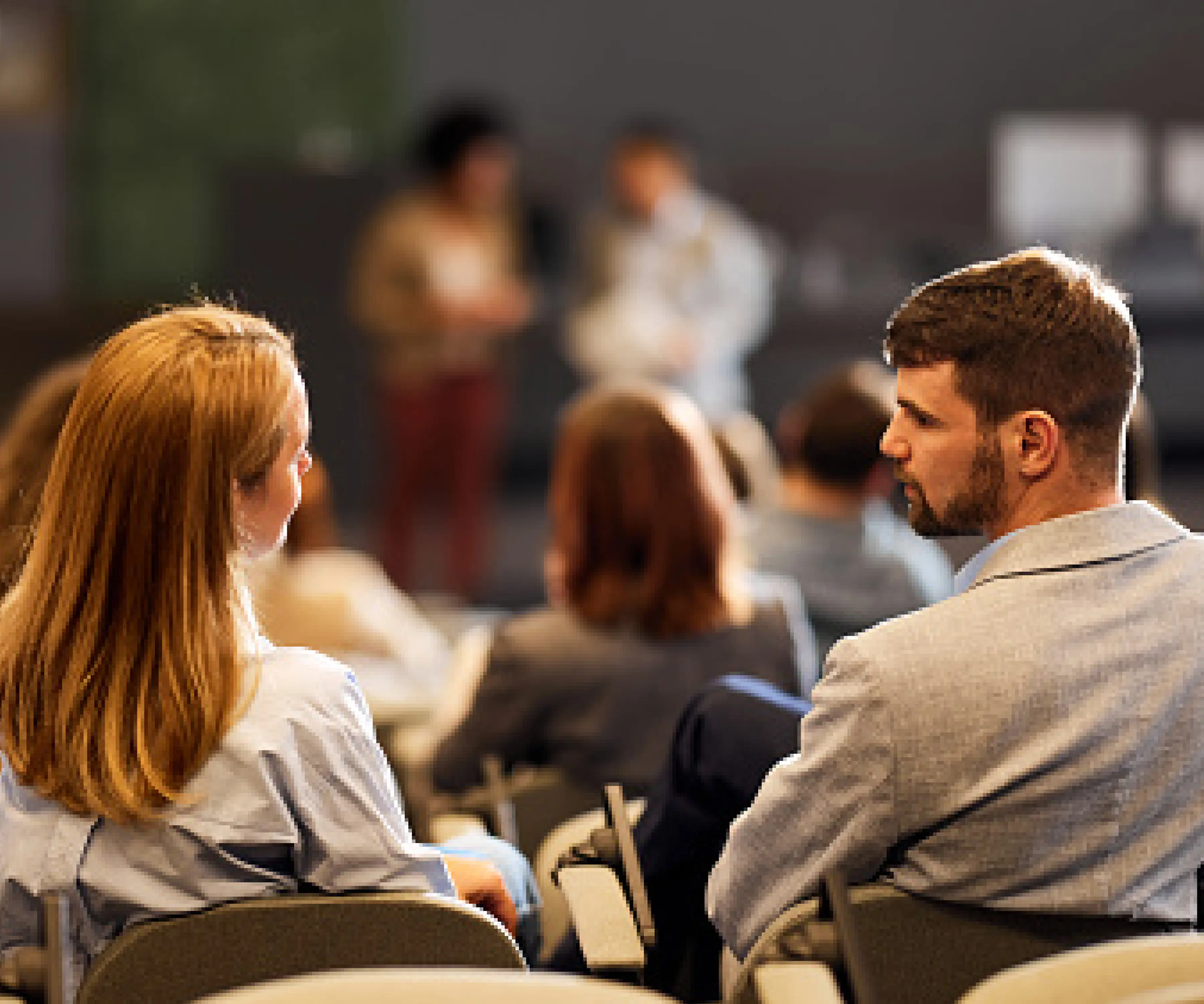 Two team members having a conversation in an open room.