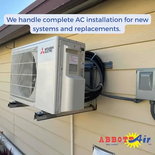 Mounted Mitsubishi Electric outdoor air conditioning unit on a home with Abbott Air logo and text about AC installation services.