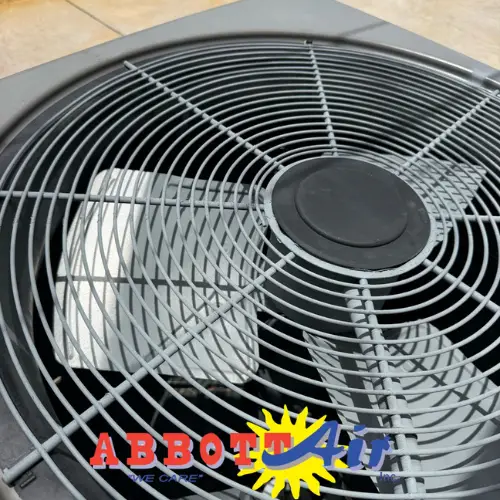 Close-up of an air conditioning unit fan with Abbott Air logo overlayed on the bottom center.