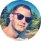 Profile picture of a man wearing sunglasses.