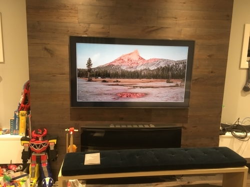 Picture of a TV mounted over a tile fireplace