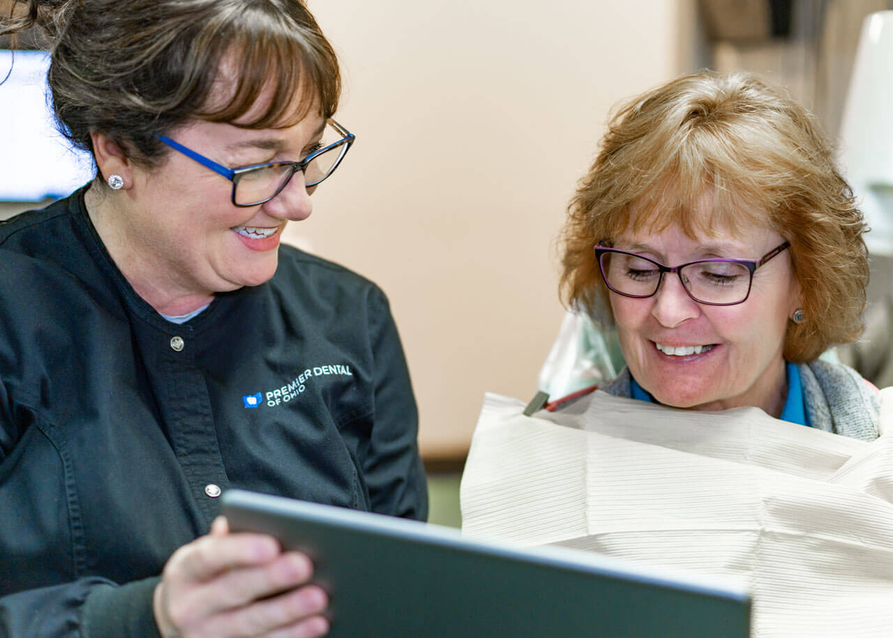 a patient learns about their options for dental crowns in ashville, oh