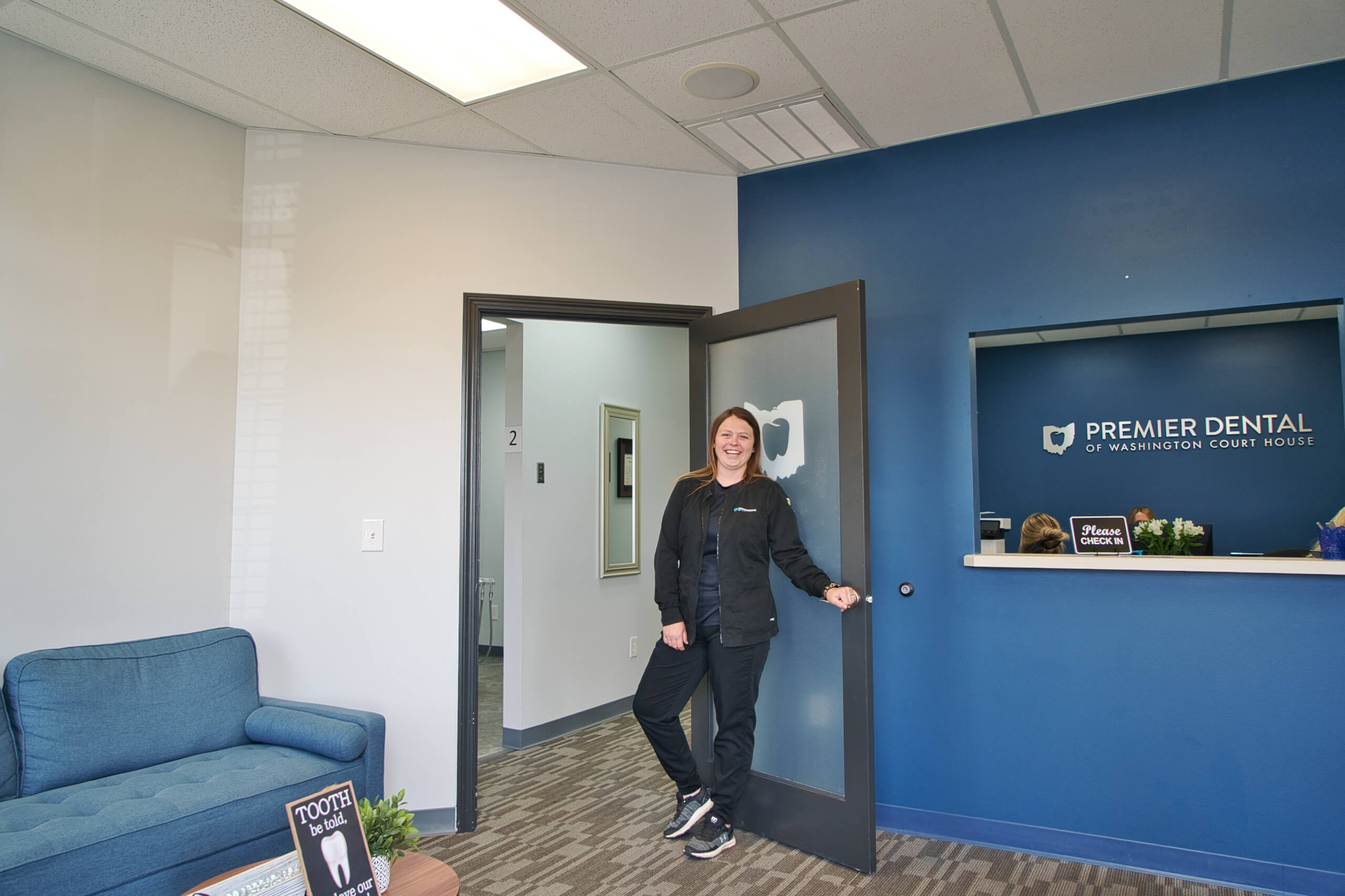 A team member ready to receive a scheduled dental patient