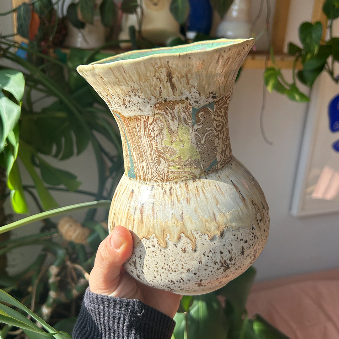 photo of a handcrated vase with colorful marbled clay.