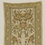 Vintage ornate beige and gold Persian rug with intricate floral and geometric design