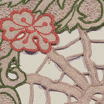 Vintage embroidered textile with red flower and green vine pattern