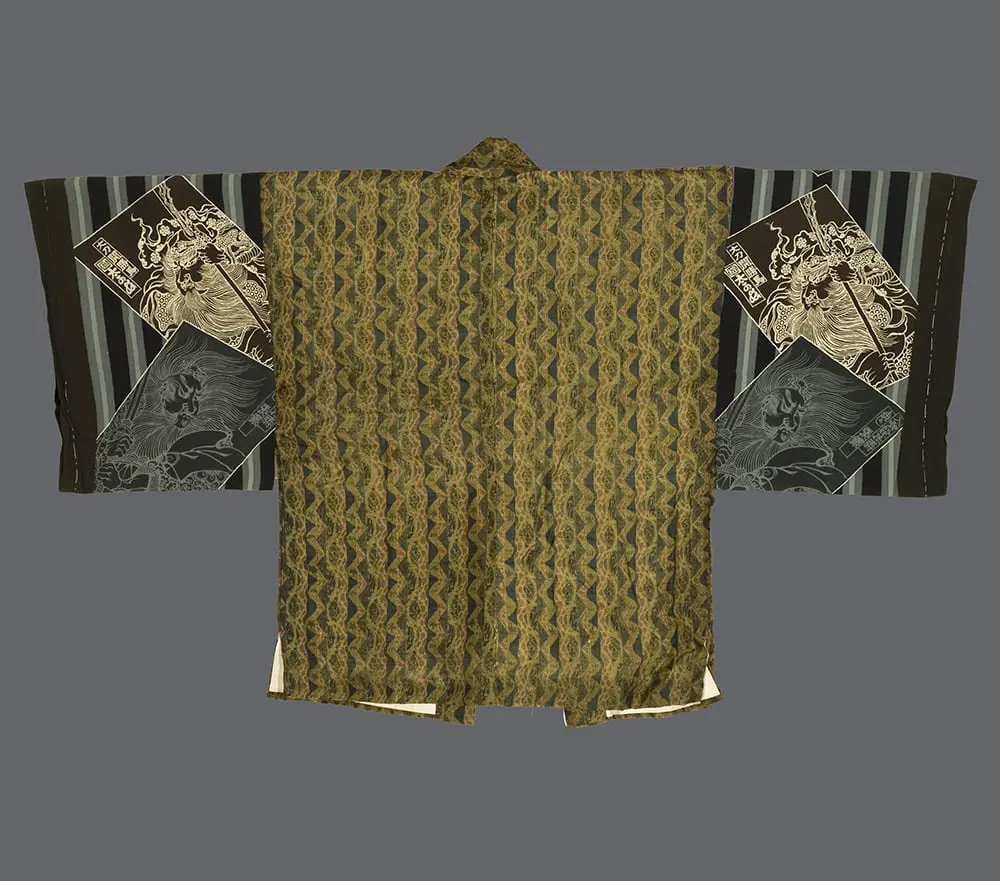 Silk hanjuban with flowing olive, rust, and sage organic forms on the body and bold black‑and‑white geometric and mythic creature motifs on the sleeves
