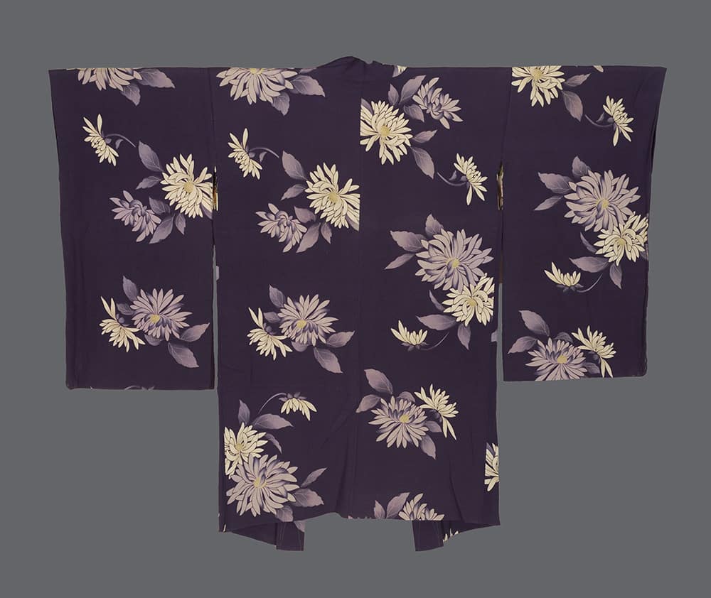 silk haori with silkscreened cream, pale lavender, and muted gold chrysanthemum motifs scattered across a rich aubergine ground in asymmetrical balance 